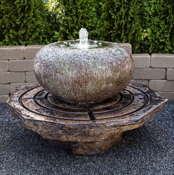 Low Organic Bowl Fountain while a plume of light dances above Modern